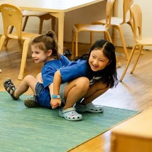 Camp Corlears - linking arms in mixed-age activity time