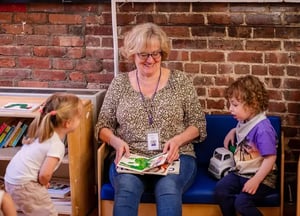 Jessica reading to Roots toddlers