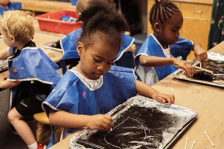 Seedlings student focused on their artwork