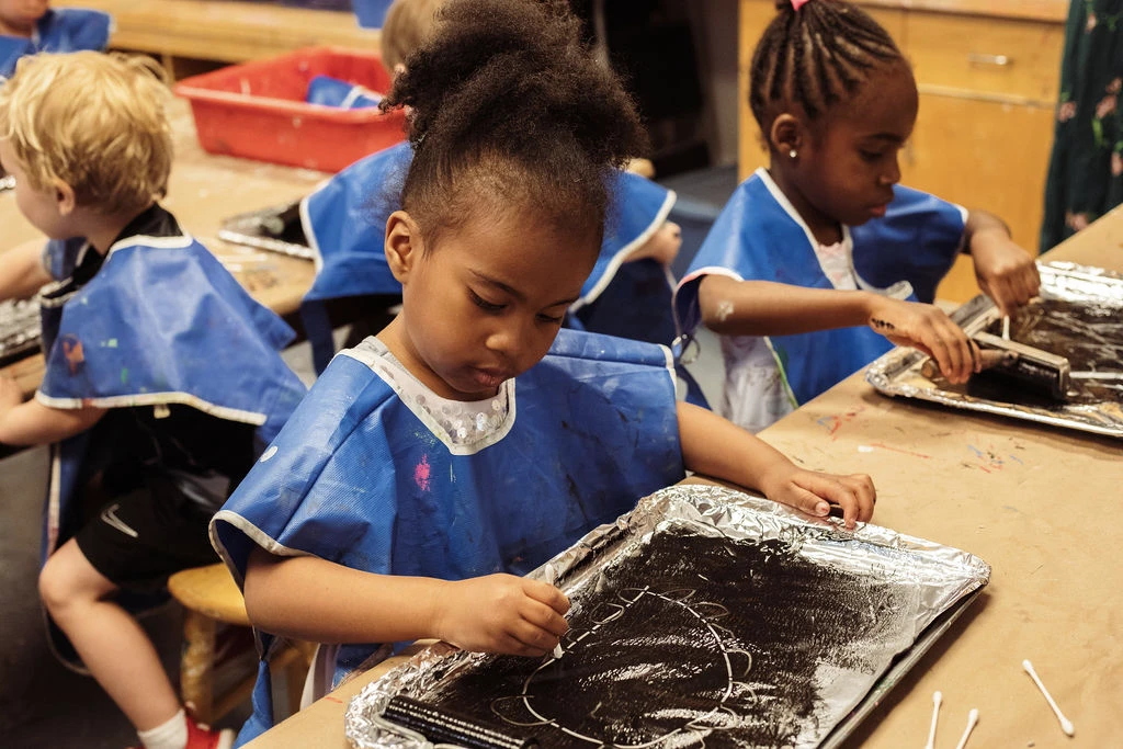 Seedlings student focused on their artwork Seedlings student focused on their artwork